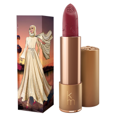 Lipstick with a decorative case featuring a woman in a hijab against a sunset background.