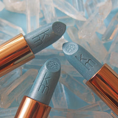 Three blue lipsticks  and blue on a light blue Icey background