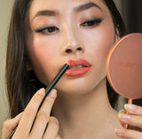 Model wearing Coral shade lipstick all natural